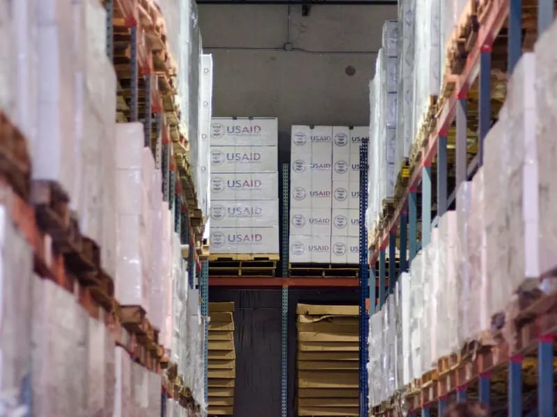 Aisles of palletised goods in a logistics warehouse