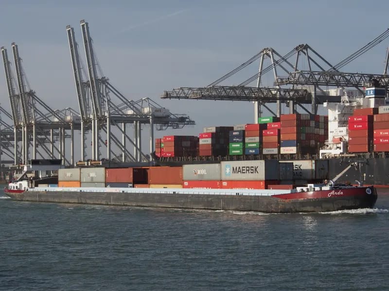 Container ship berthed at a port terminal with gantry cranes