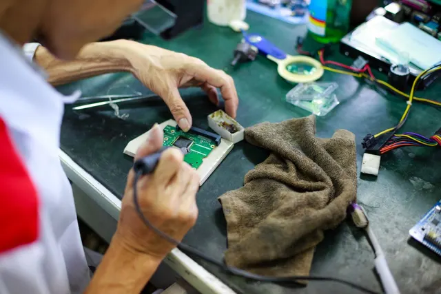 Technician matching a component on a PCB against the bill of materials